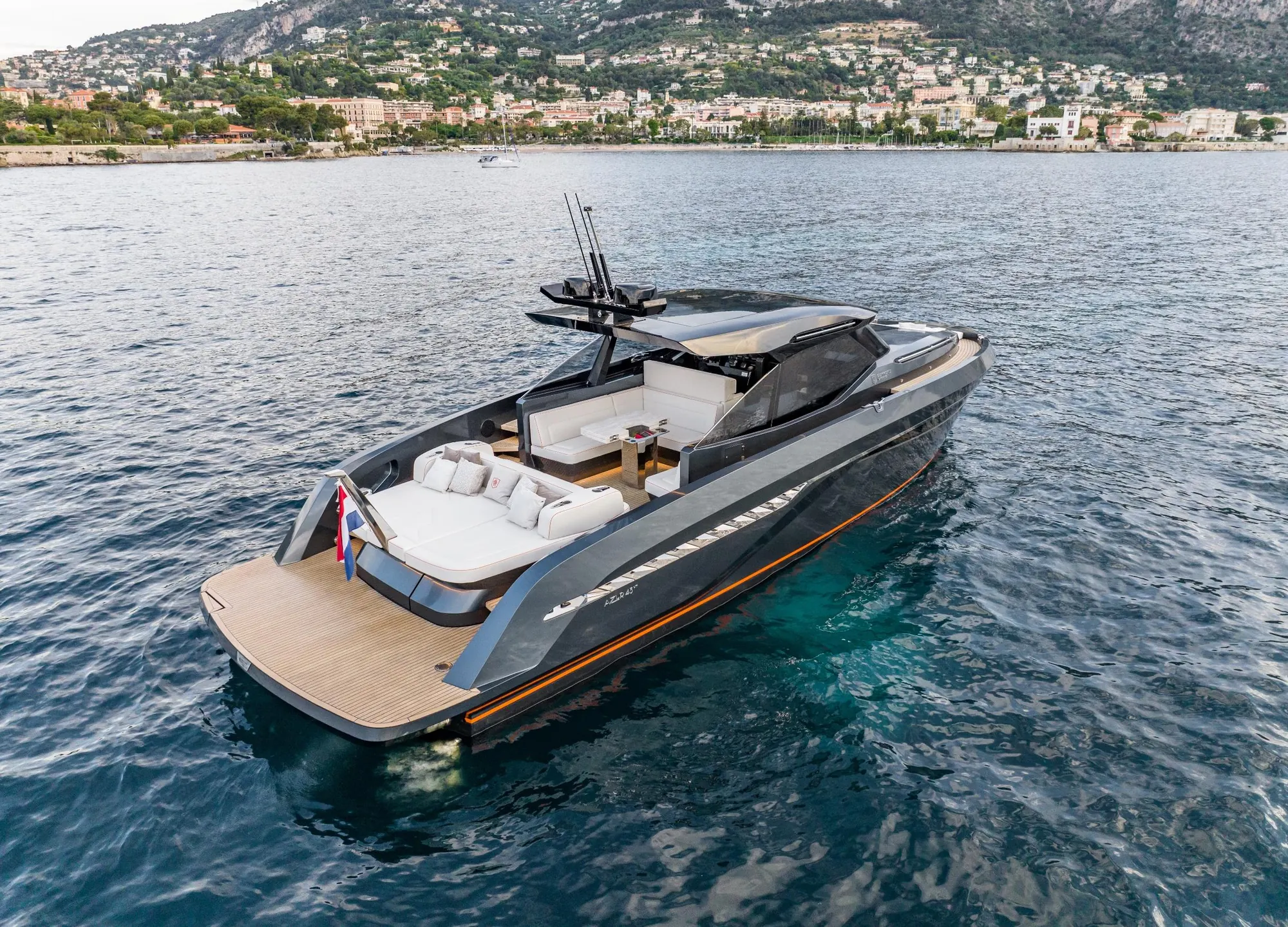 Motor yacht at speed near the coast