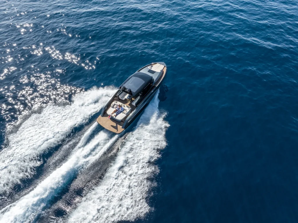 Aerial view of a yacht leaving a white wake